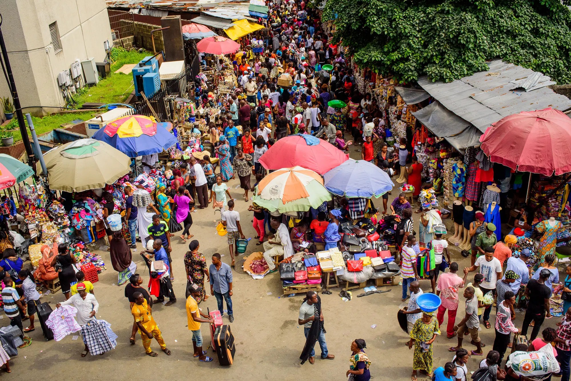 A market street under coloured umbrellas.