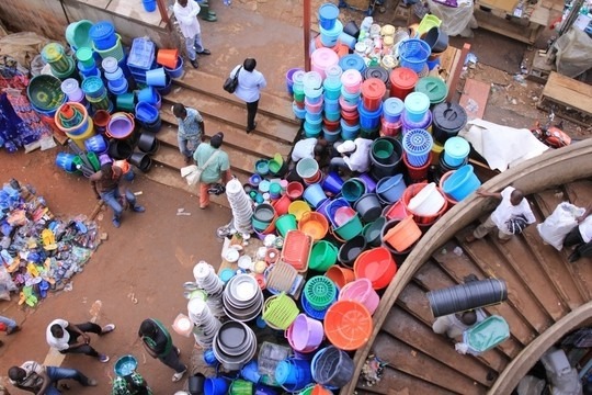 Seen from above, steps stacked with plastic buckets and basins in every colour.
